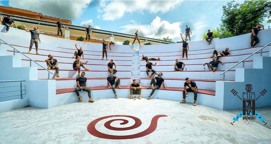 tourists sitting on stone amphitheater at Ktima Brintziki winery